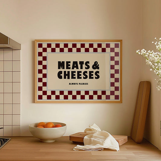 Kitchen interior with a framed sign reading 'MEATS & CHEESES ALWAYS PLEASE' on the wall.