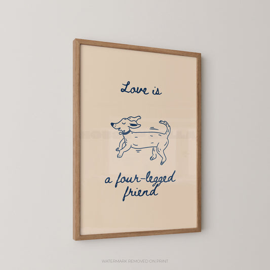 A framed art print featuring a pink background with a navy blue line drawing of a dog and the text 'Love is a four-legged friend' in blue script, displayed on a light gray wall.