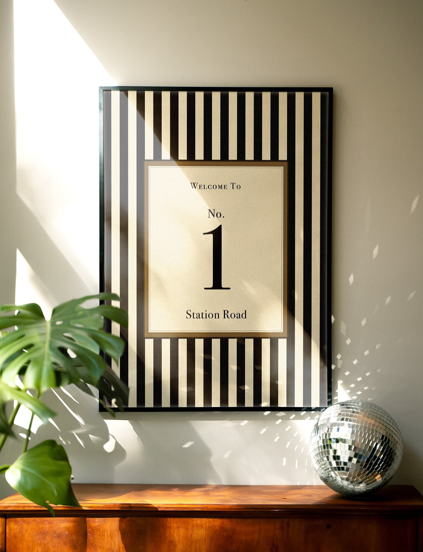 House of Zella personalised house number wall art with black striped design styled in a modern home interior.