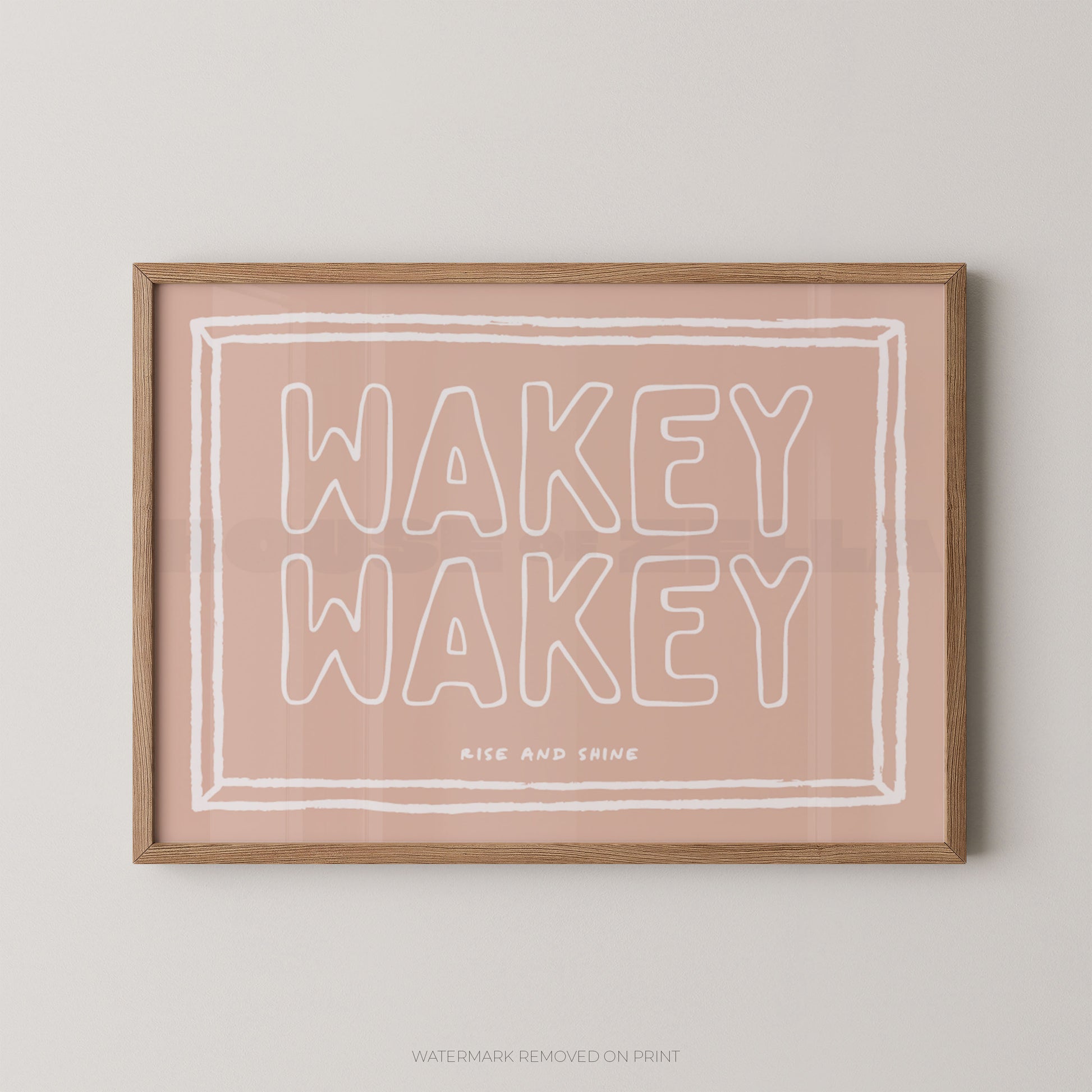 Framed print with 'Wakey Wakey' text on a pink background