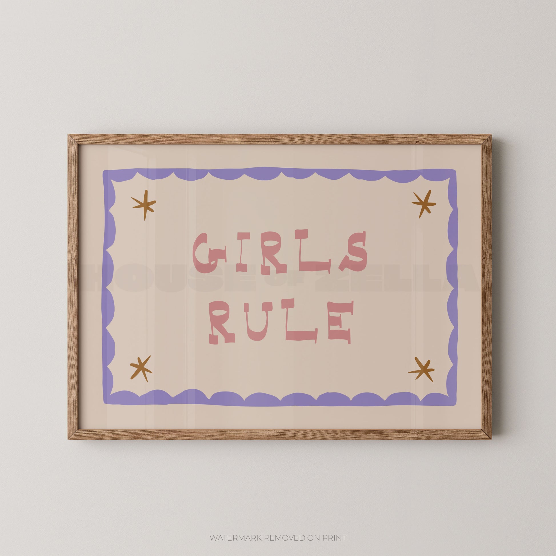 "Girls Rule children's wall art print with bold pink retro lettering on a cream background, purple scallop border with gold star details in each corner, displayed straight-on in an oak frame"

