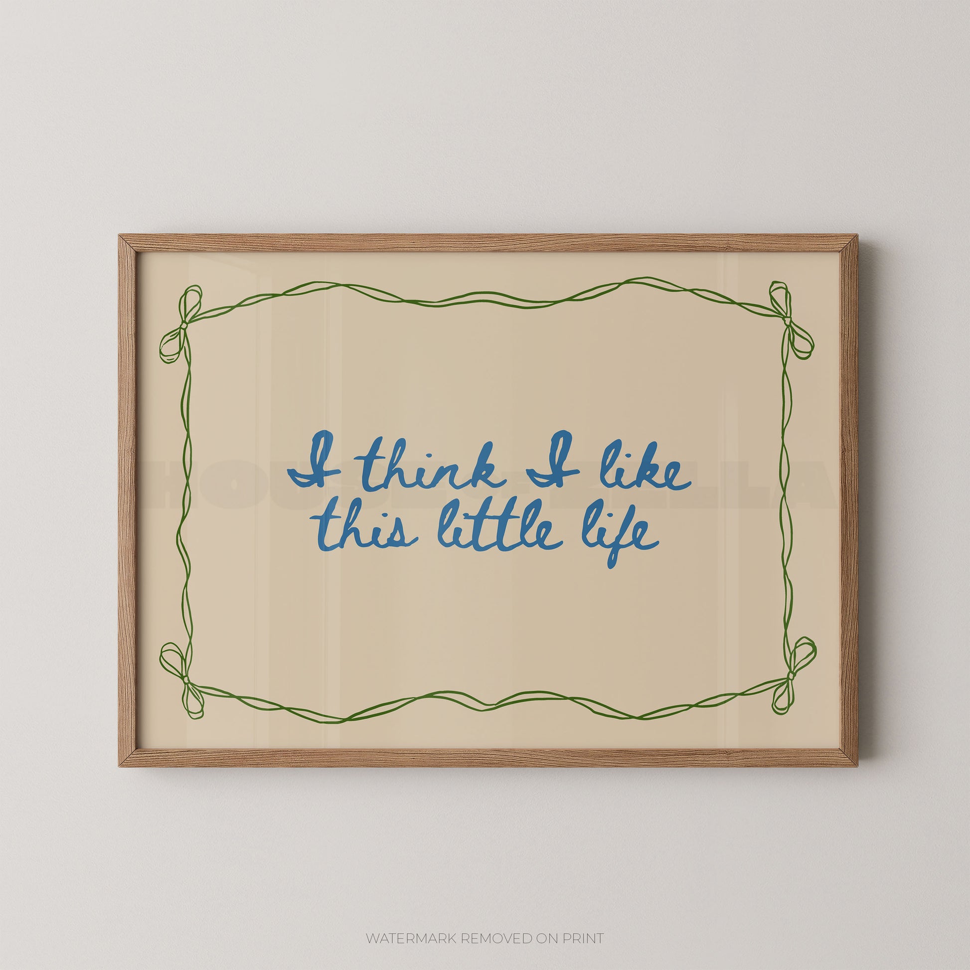 Framed print with 'I think I like this little life' text on a beige background