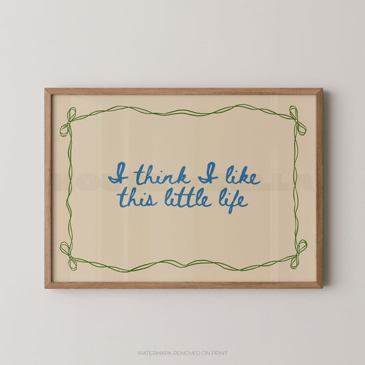 Framed print with 'I think I like this little life' text on a beige background
