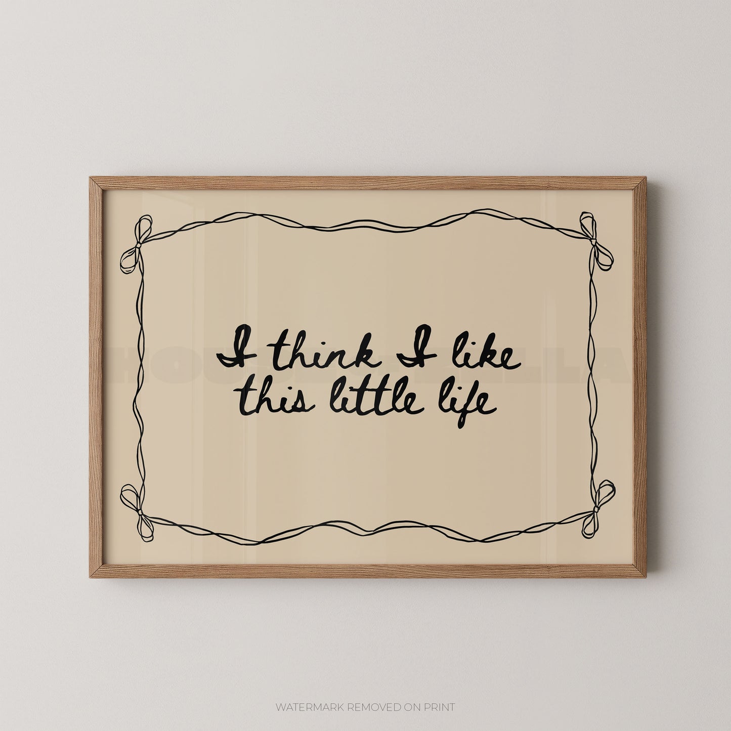 Framed print with 'I think I like this little life' text on a beige background