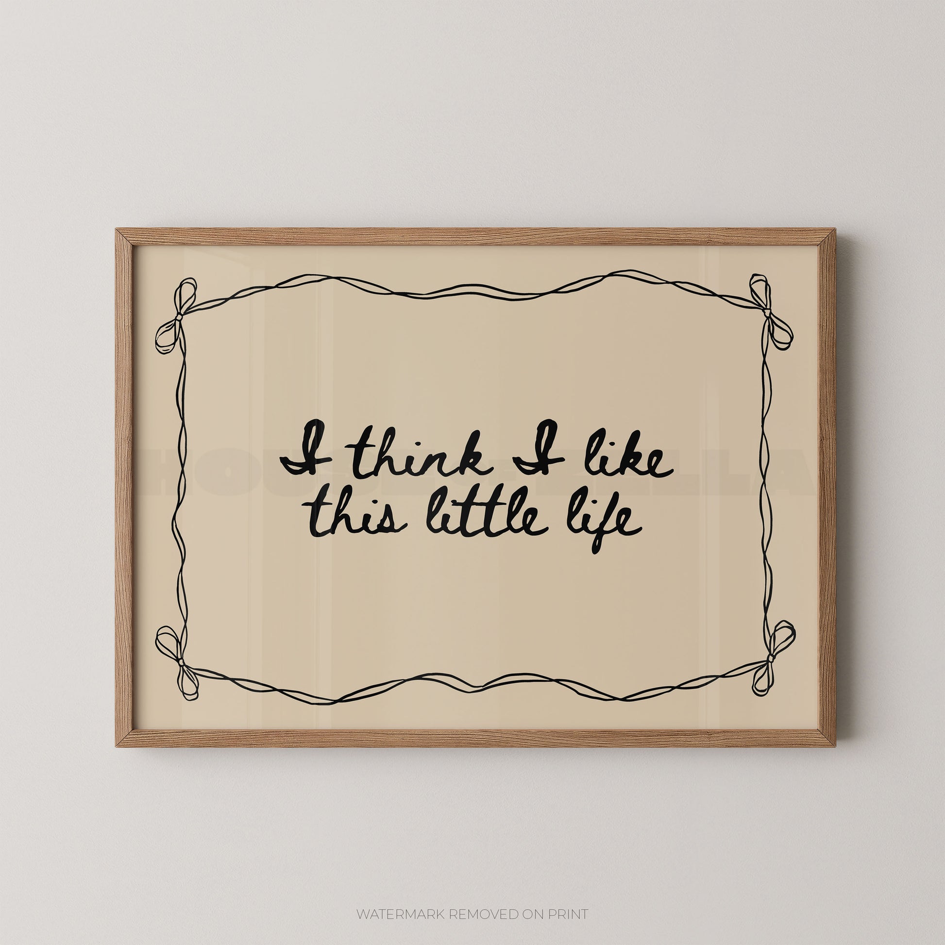 Framed print with 'I think I like this little life' text on a beige background