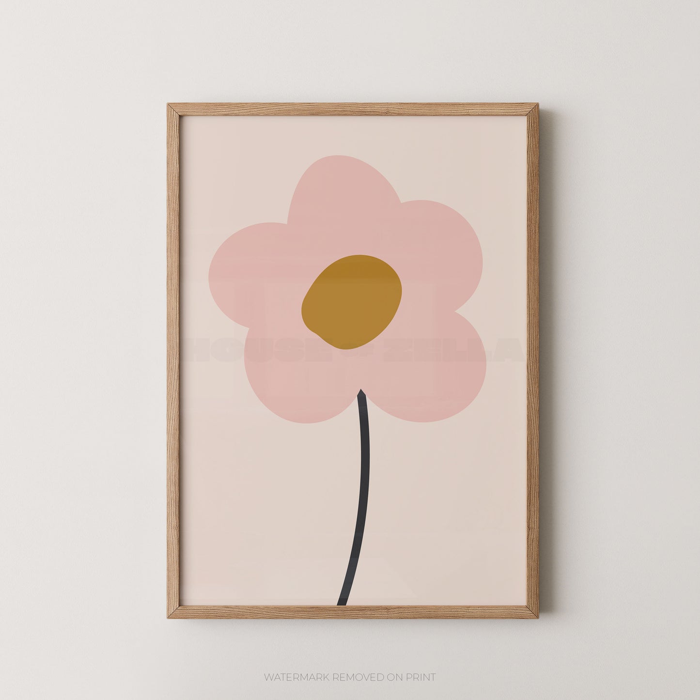 Framed minimalist floral wall art featuring a large pink flower with a mustard yellow center and a black stem on a pale blush background, shown in a light wood frame against a white wall.