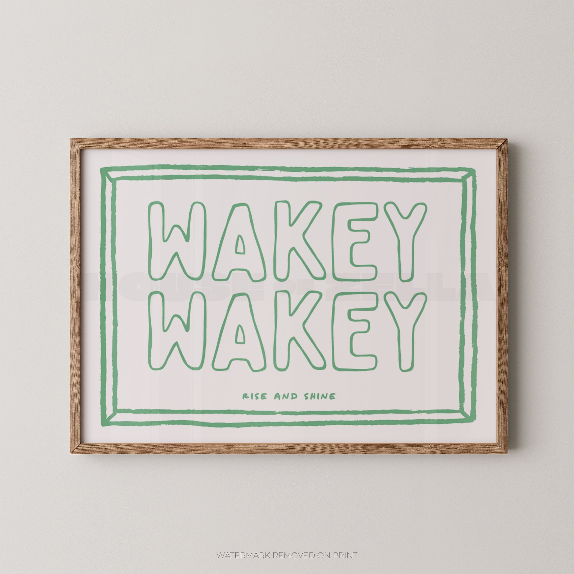 Framed print with 'Wakey Wakey' text in green on a white background