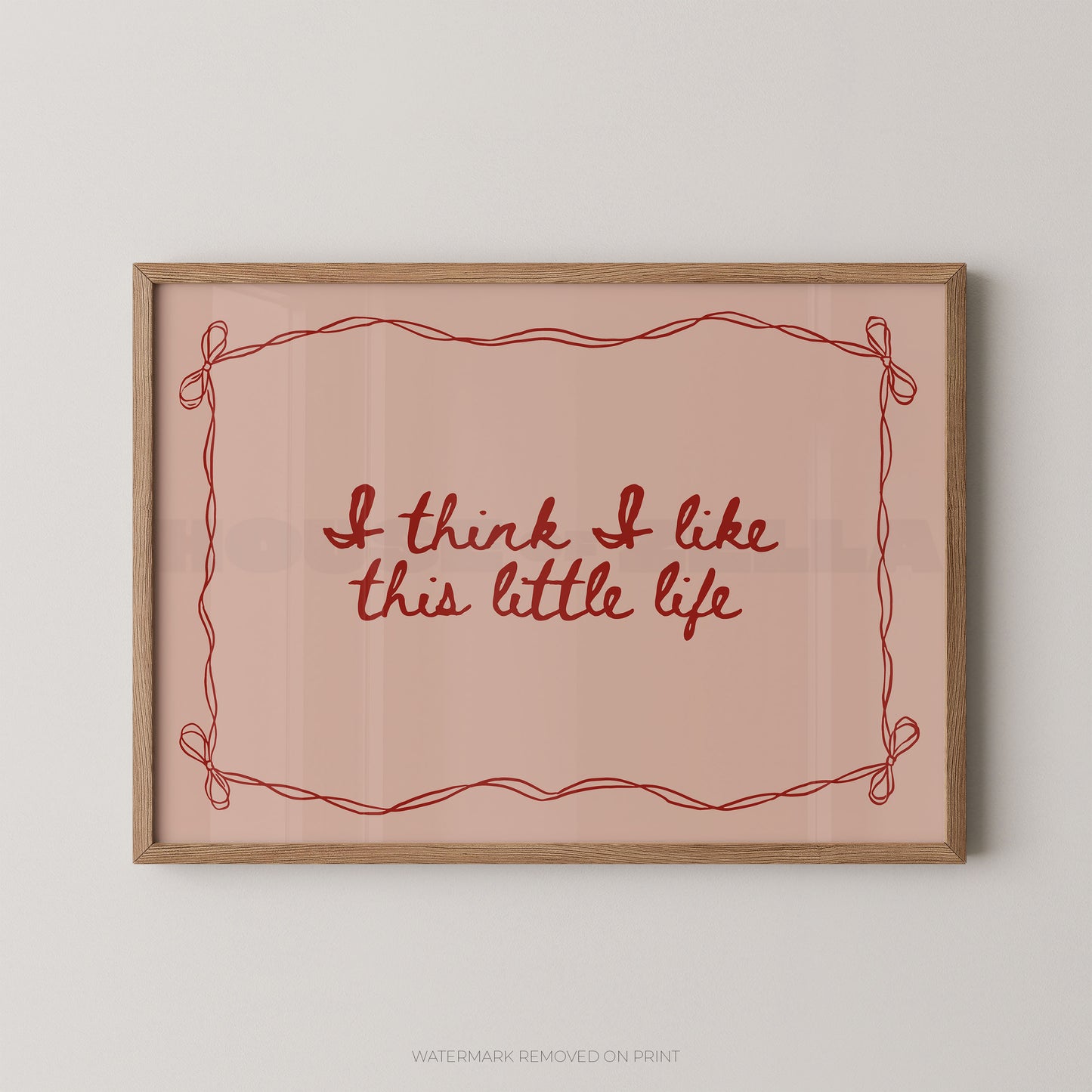 Framed print with 'I think I like this little life' text on a pink background