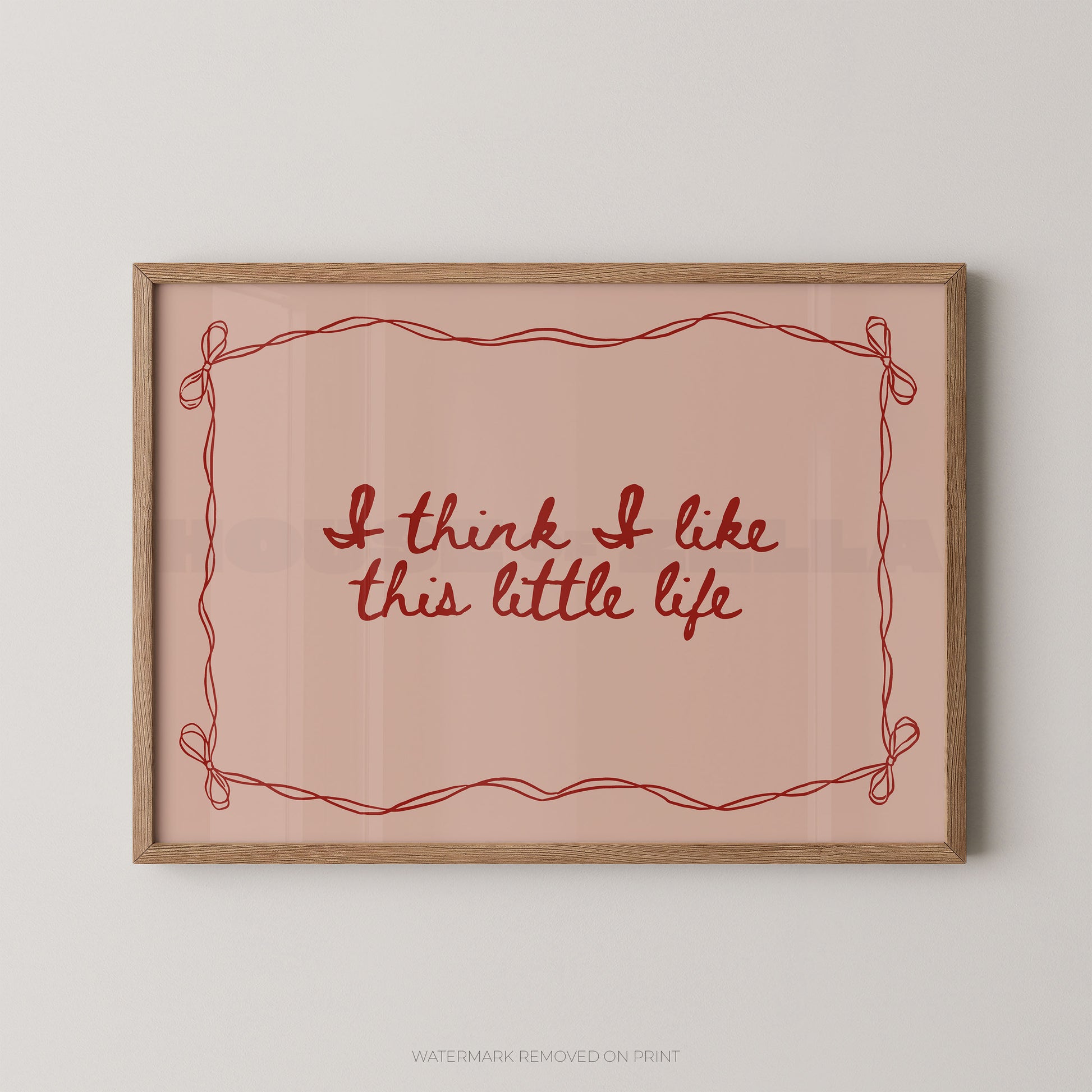Framed print with 'I think I like this little life' text on a pink background