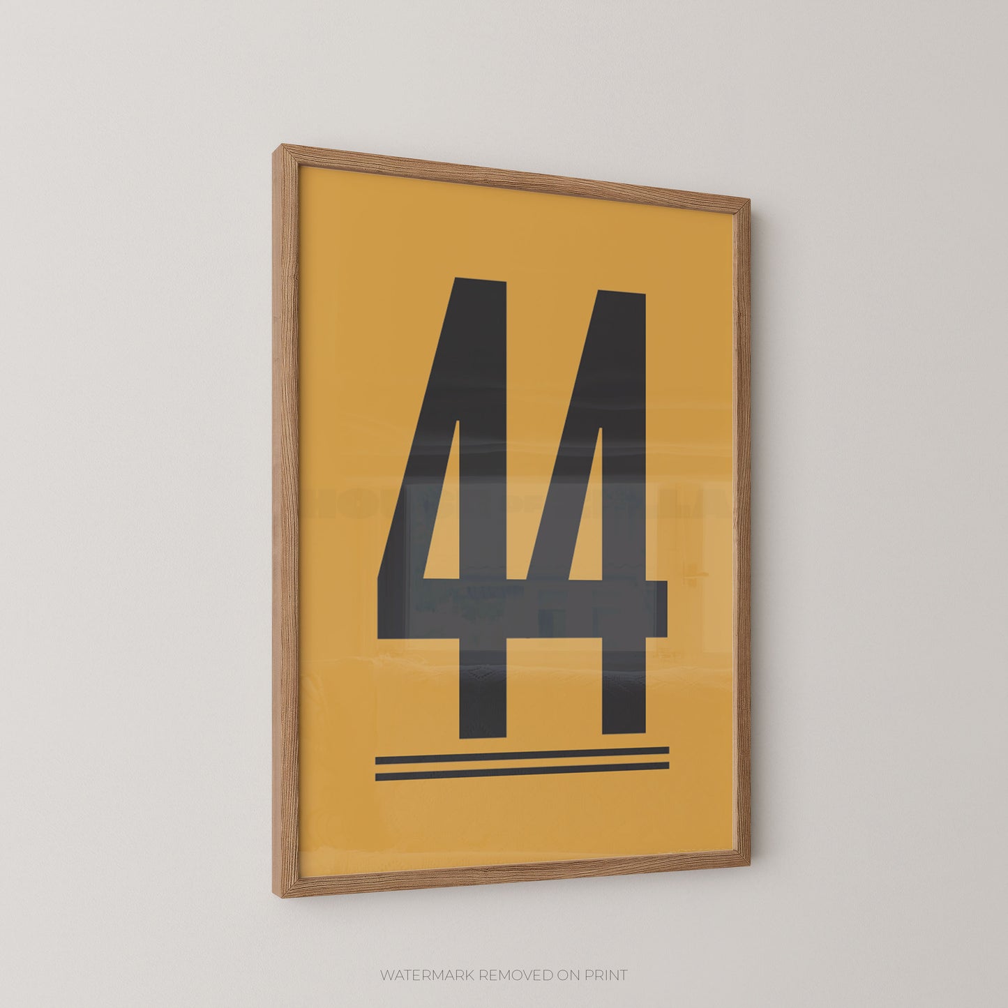 Framed minimalist wall art featuring a large black number 44 on a mustard yellow background, enclosed in a light natural wood frame and shown hanging on a light gray wall.