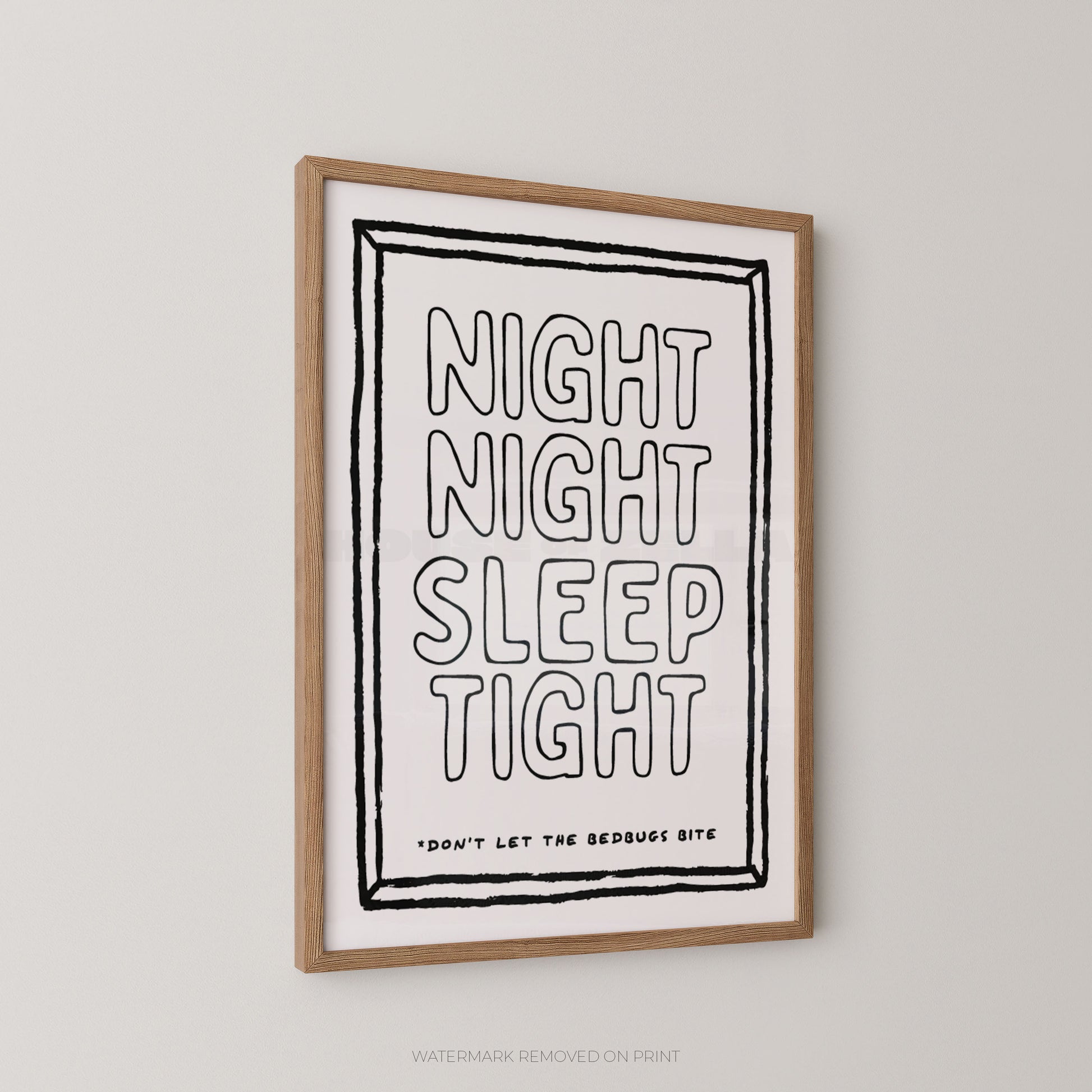 A framed typographic wall art print hanging on a light neutral wall. The print has a white background with black hand-drawn style text reading “NIGHT NIGHT SLEEP TIGHT” and smaller text below, plus a natural wood frame.
