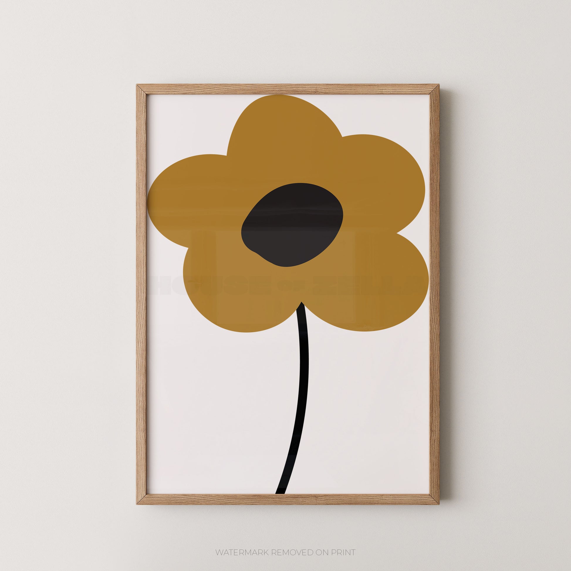 Framed minimalist floral wall art featuring a large mustard-yellow flower with a black center and stem on a white background, set in a light natural wood frame against a warm off-white wall.