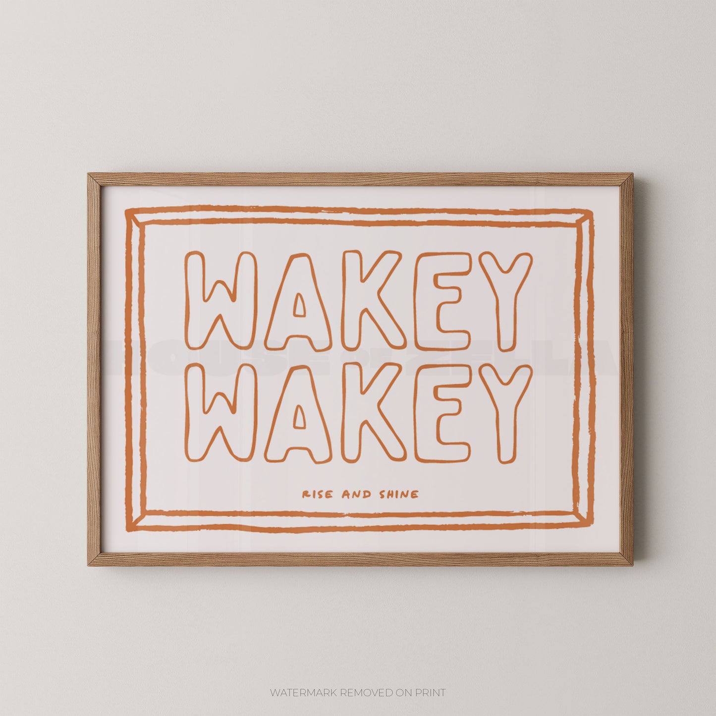 Framed print with 'Wakey Wakey' text on a plain background
