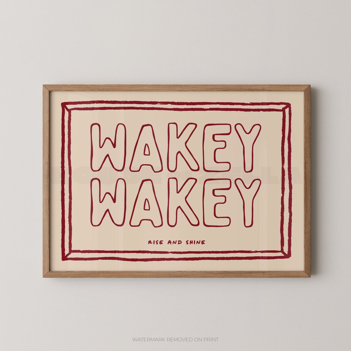 Framed artwork with 'Wakey Wakey' text on a beige background