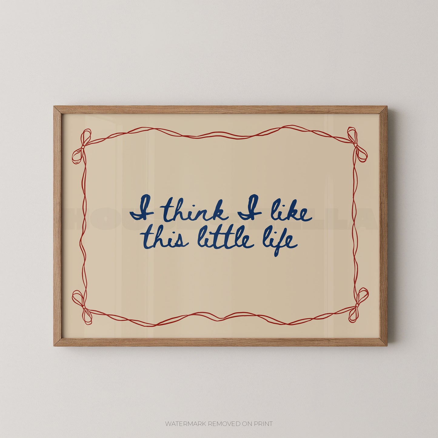 Framed print with 'I think I like this little life' text on a beige background