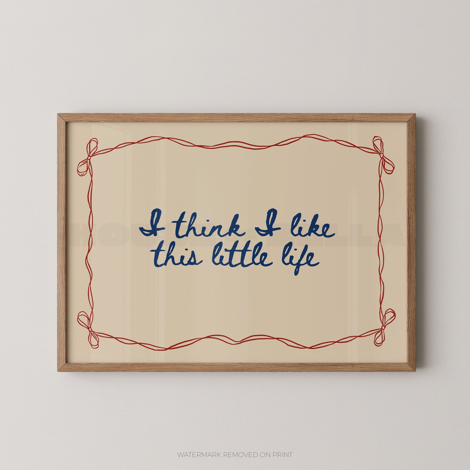 Framed print with 'I think I like this little life' text on a beige background