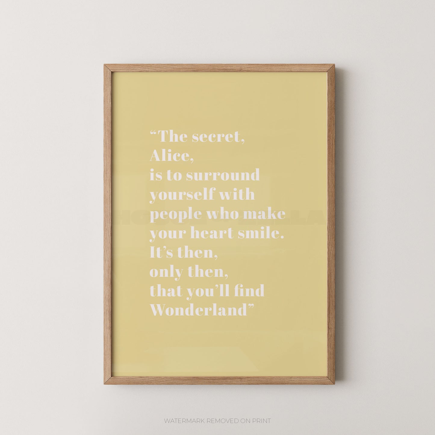 Framed yellow print with a quote on a white wall