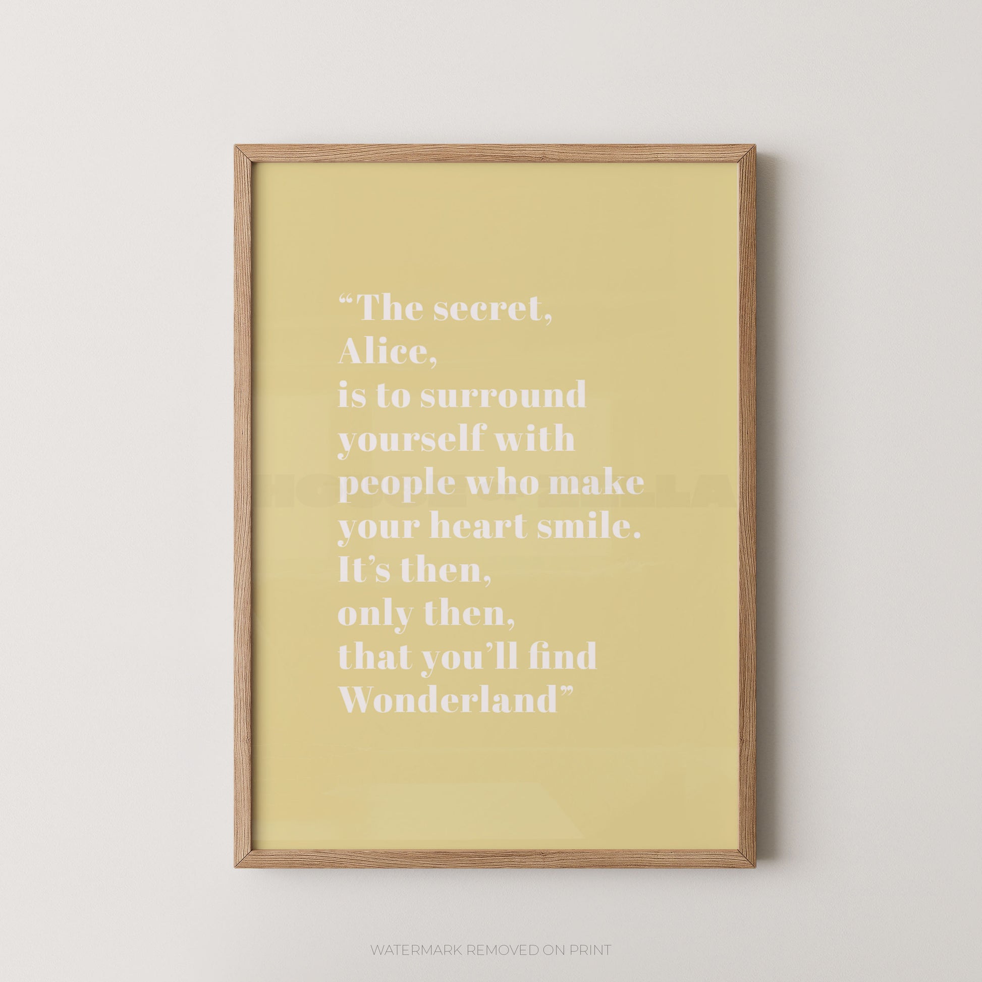 Framed yellow print with a quote on a white wall