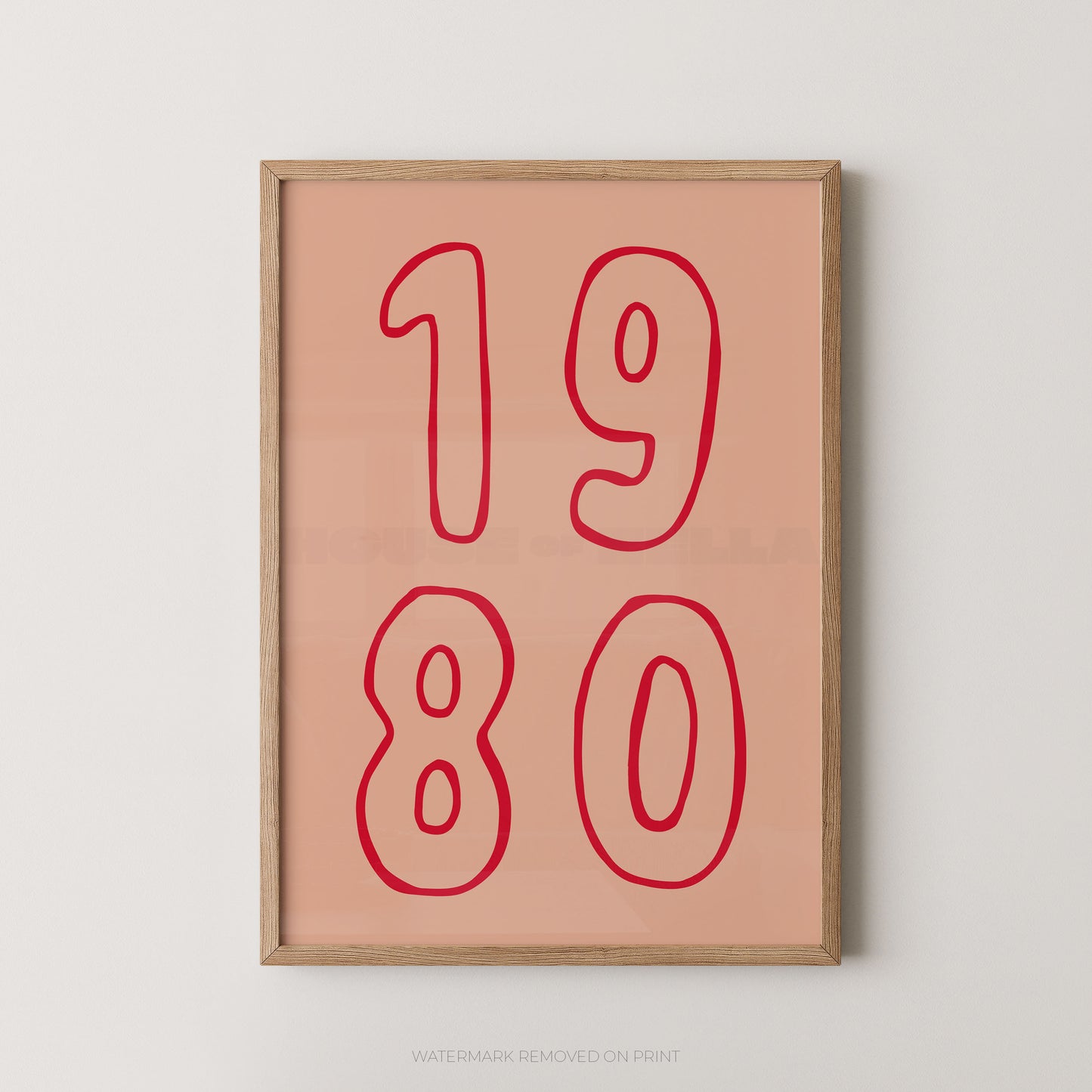 Framed wall art print with the numbers '1980' in red outline on a peach background, shown hanging against a light gray wall.