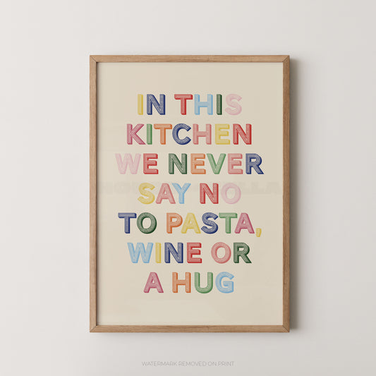 A framed typographic wall art print with the phrase “IN THIS KITCHEN WE NEVER SAY NO TO PASTA, WINE OR A HUG” in colorful block letters on a cream background, shown hanging against a light neutral wall.
