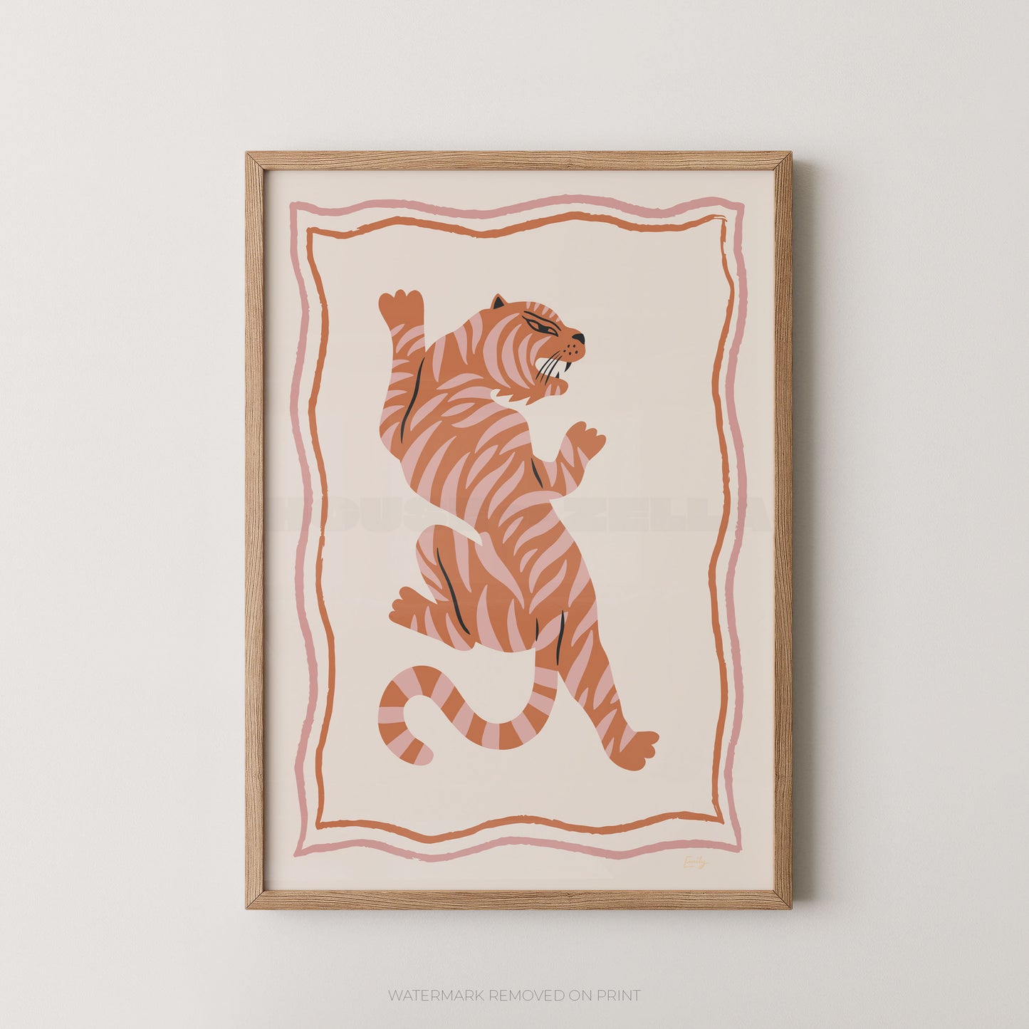 Framed wall art featuring a stylized orange tiger with black stripes on a cream background, bordered by pink wavy lines, shown in a light wood frame against a light gray wall.