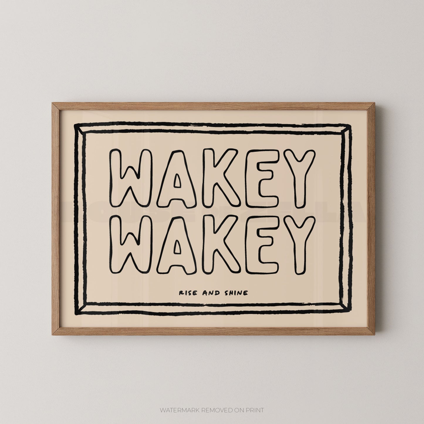Framed artwork with 'Wakey Wakey' text on a beige background