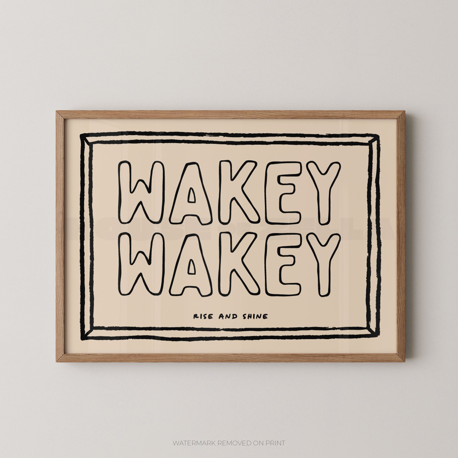 Framed artwork with 'Wakey Wakey' text on a beige background