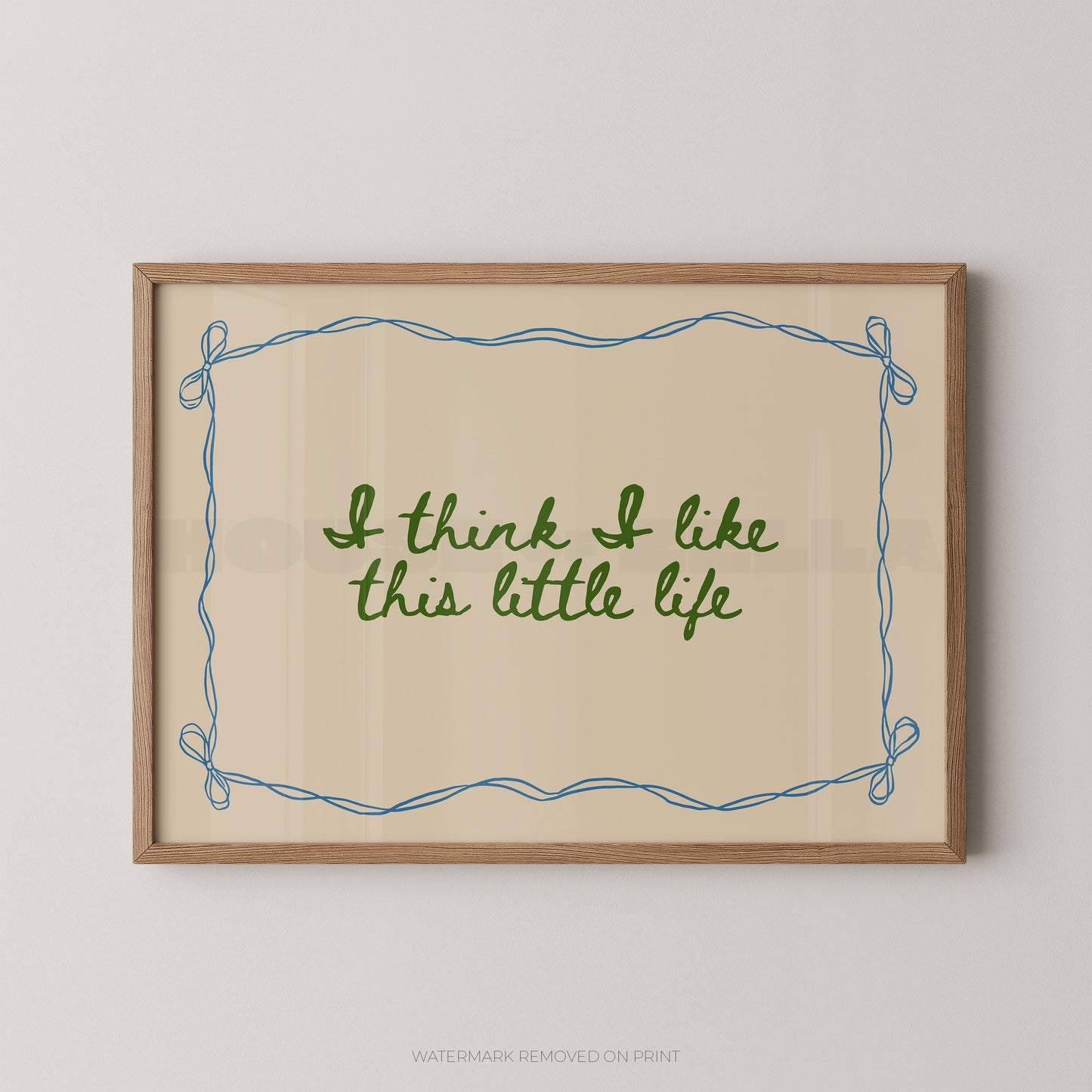 Framed print with 'I think I like this little life' text on a beige background