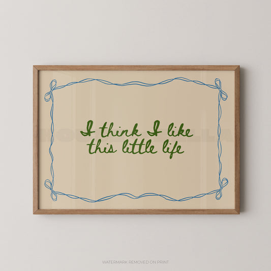 Framed print with 'I think I like this little life' text on a beige background