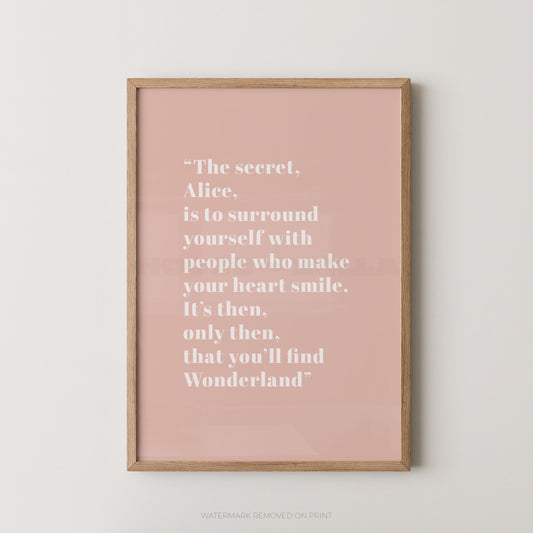 Framed pink poster with a quote on a white wall