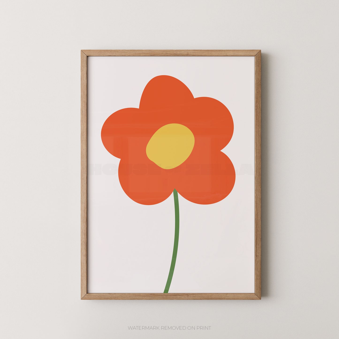 Framed minimalist floral wall art featuring a stylized orange flower with a yellow center and green stem on a white background, set in a light natural wood frame against a neutral wall.