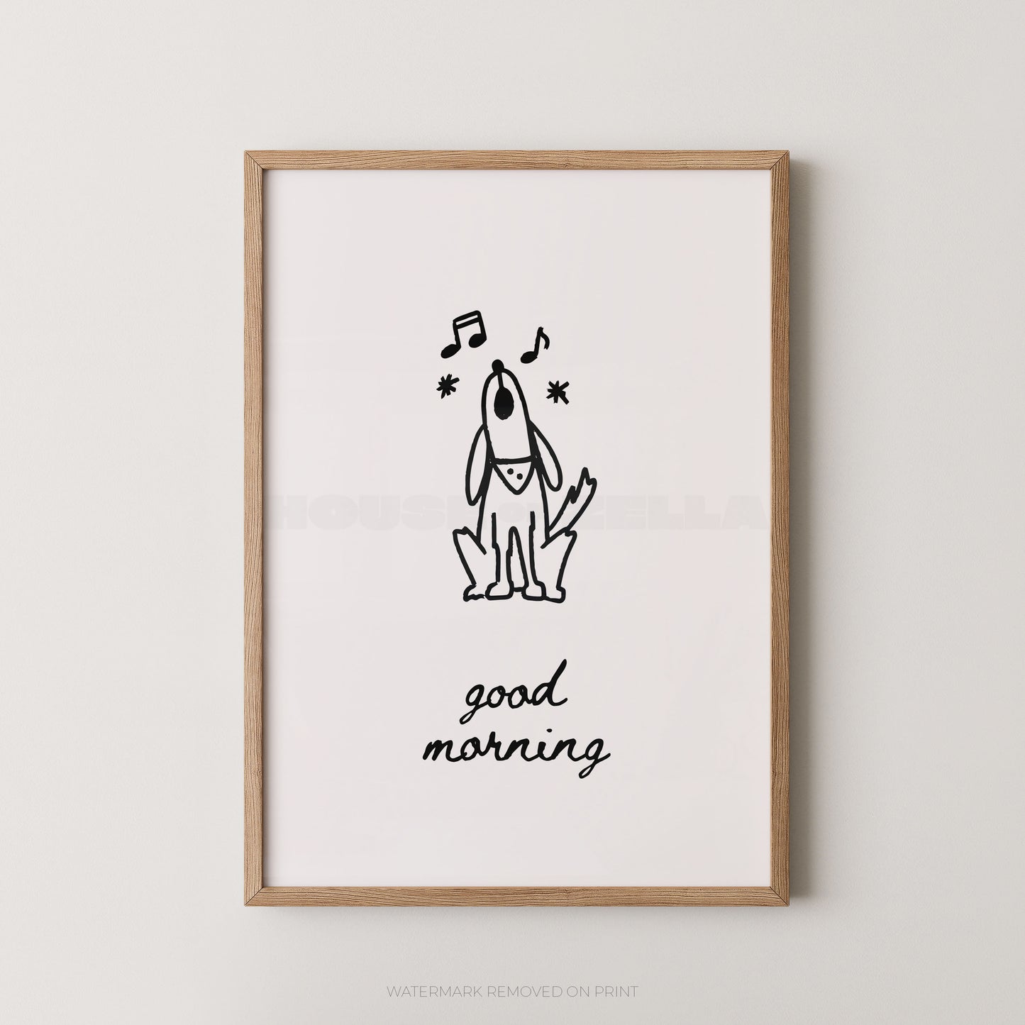 A framed wall art print featuring a simple black line drawing of a dog with musical notes and the words 'good morning' in black script on a white background, enclosed in a light natural wood frame.