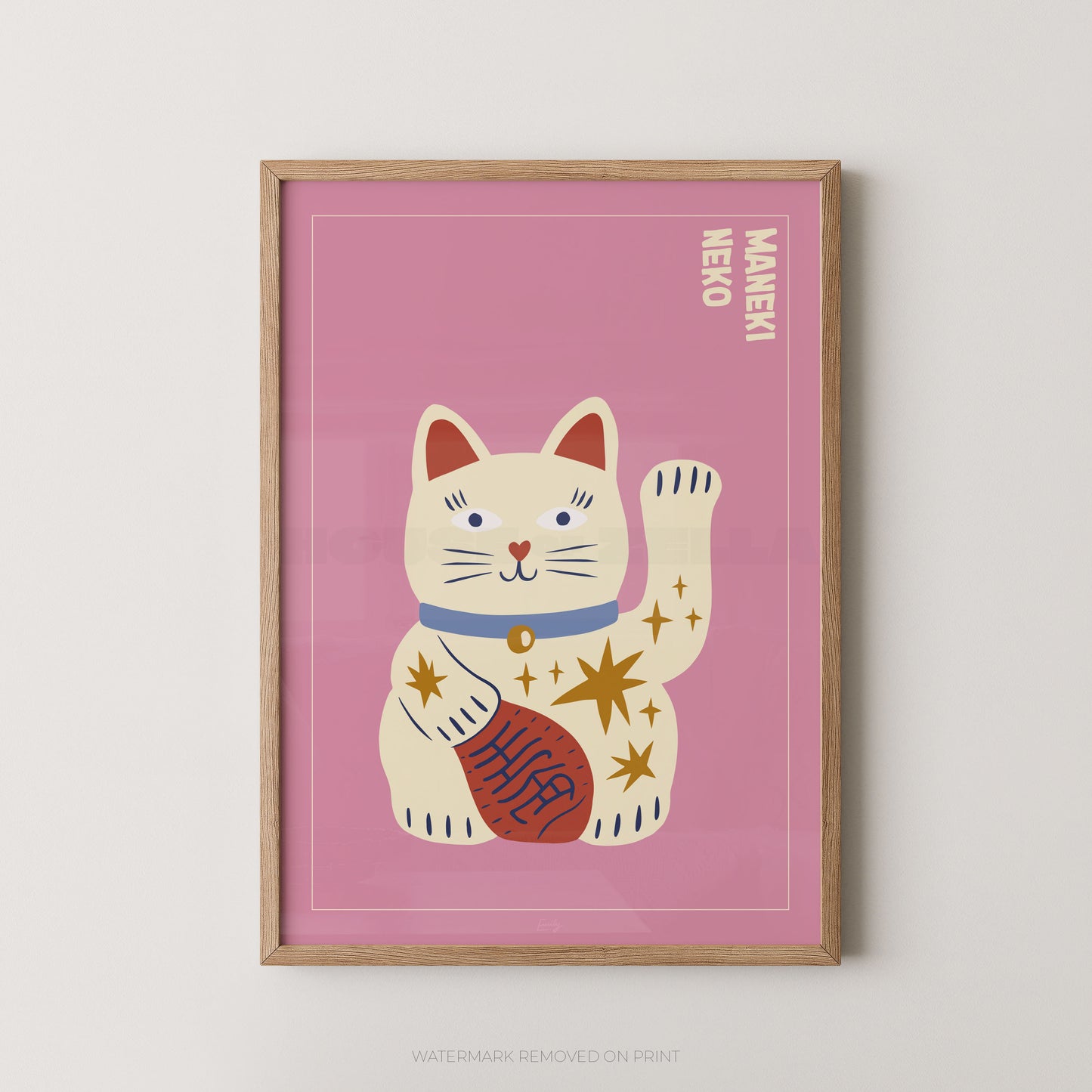 Framed artwork of a cartoon cat with a pink background, featuring the word 'Maneki' on a white wall.