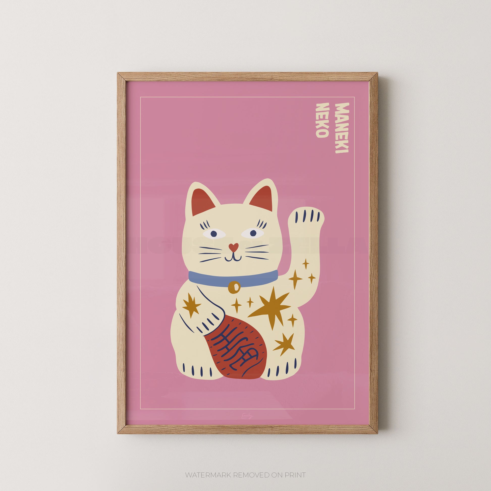 Framed artwork of a cartoon cat with a pink background, featuring the word 'Maneki' on a white wall.