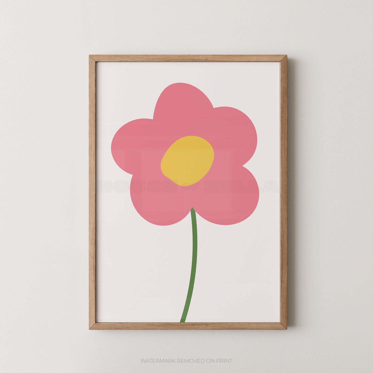 Framed minimalist floral wall art featuring a pink flower with a yellow center and green stem on a white background, set in a light natural wood frame against a neutral wall.