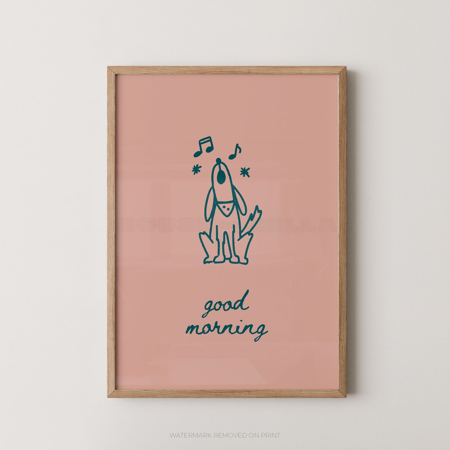 A framed art print featuring a minimalist navy blue line drawing of a dog with musical notes and the text 'good morning' on a dusty pink background, enclosed in a light wood frame.