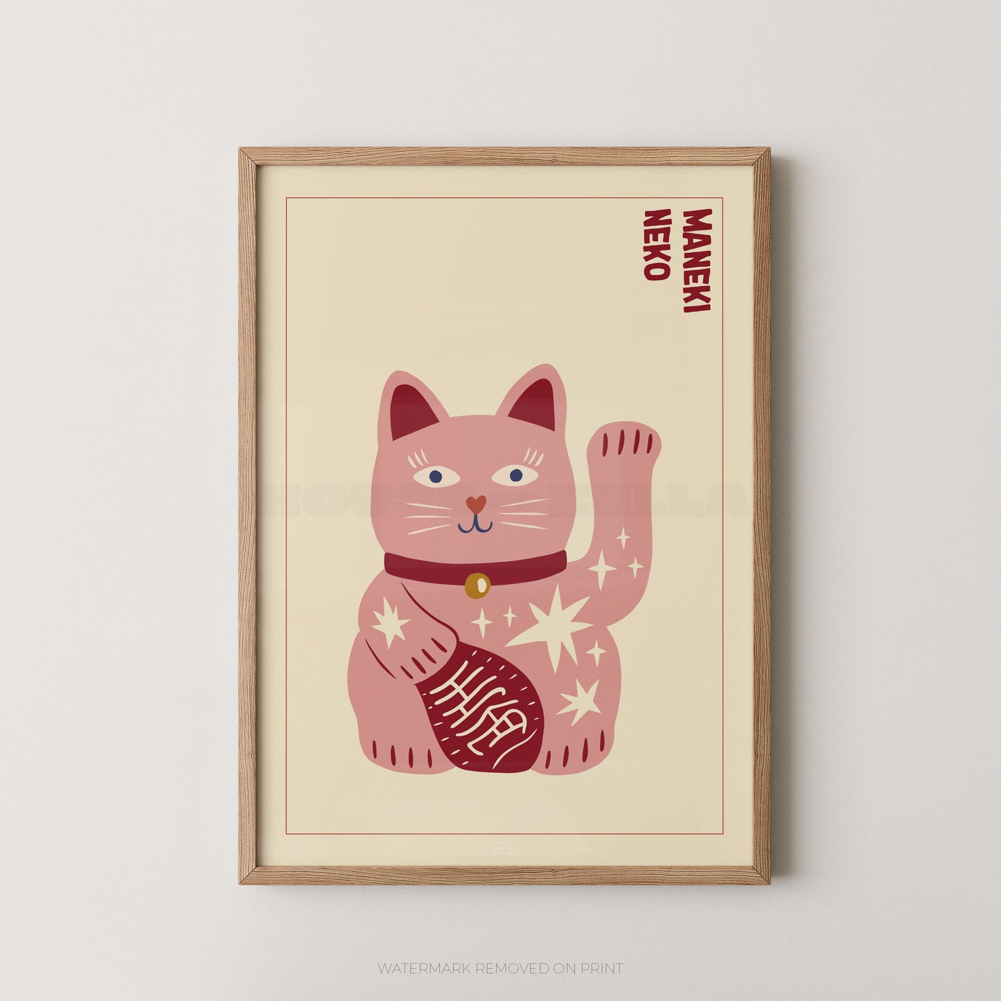Framed artwork of a pink Maneki Neko cat on a beige background
