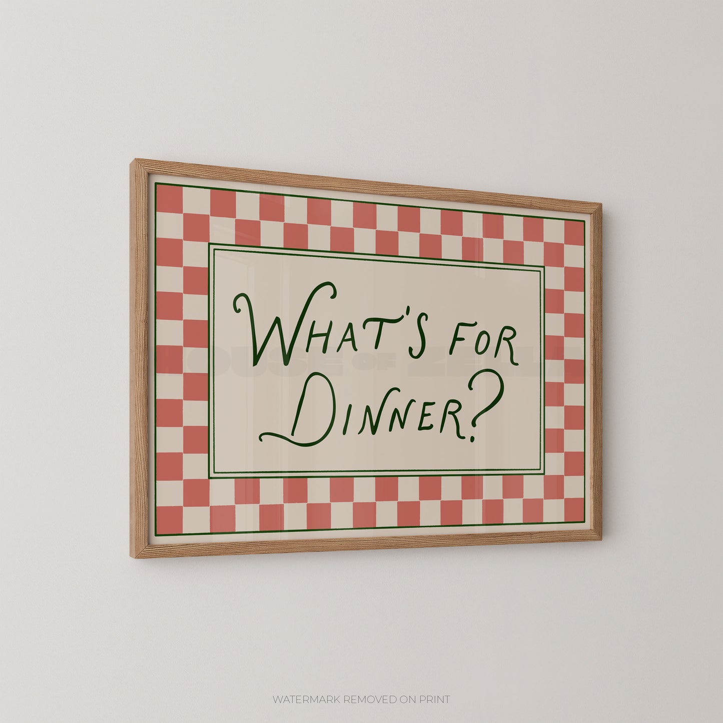 Framed checkered sign with 'What's for Dinner?' text on a white wall
