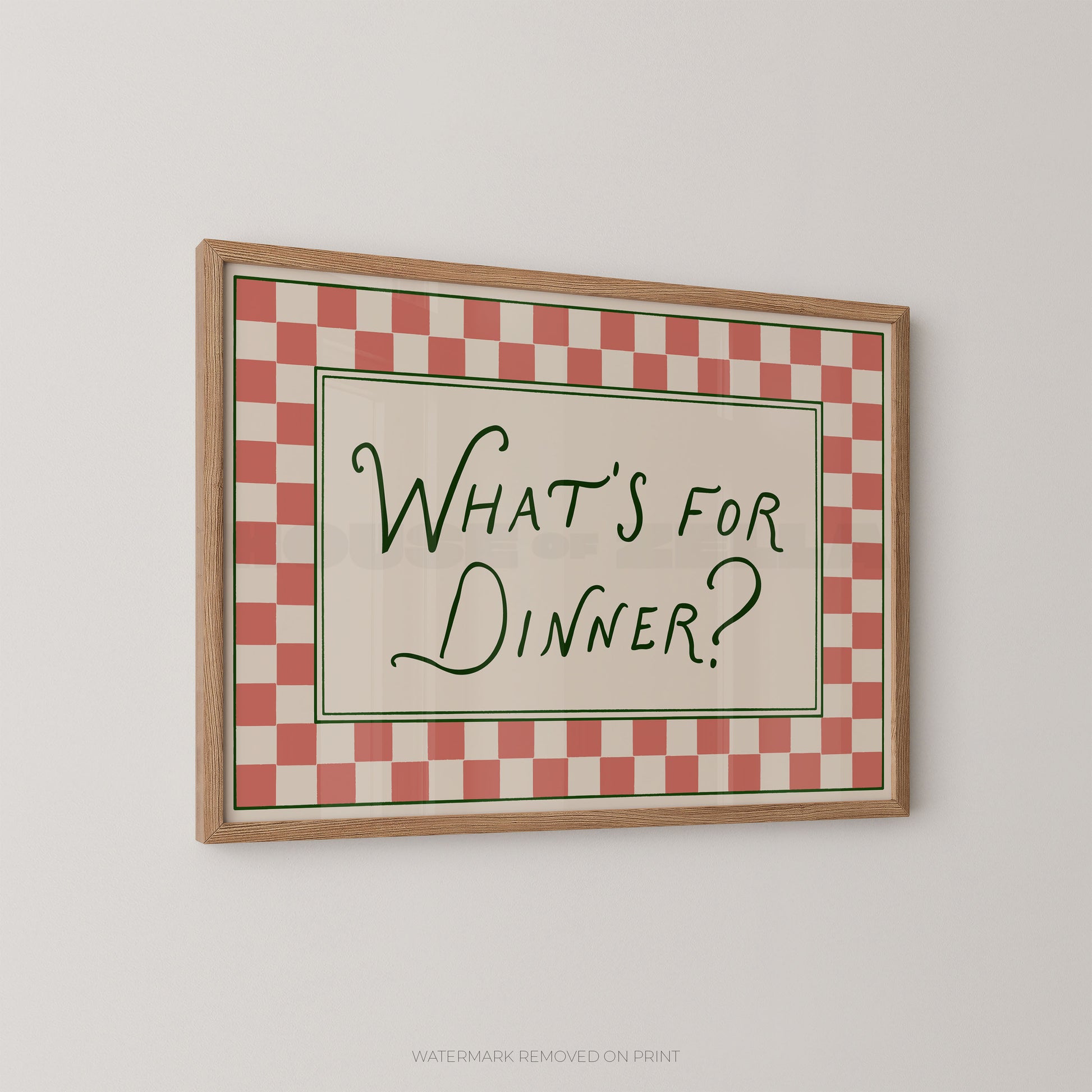Framed checkered sign with 'What's for Dinner?' text on a white wall