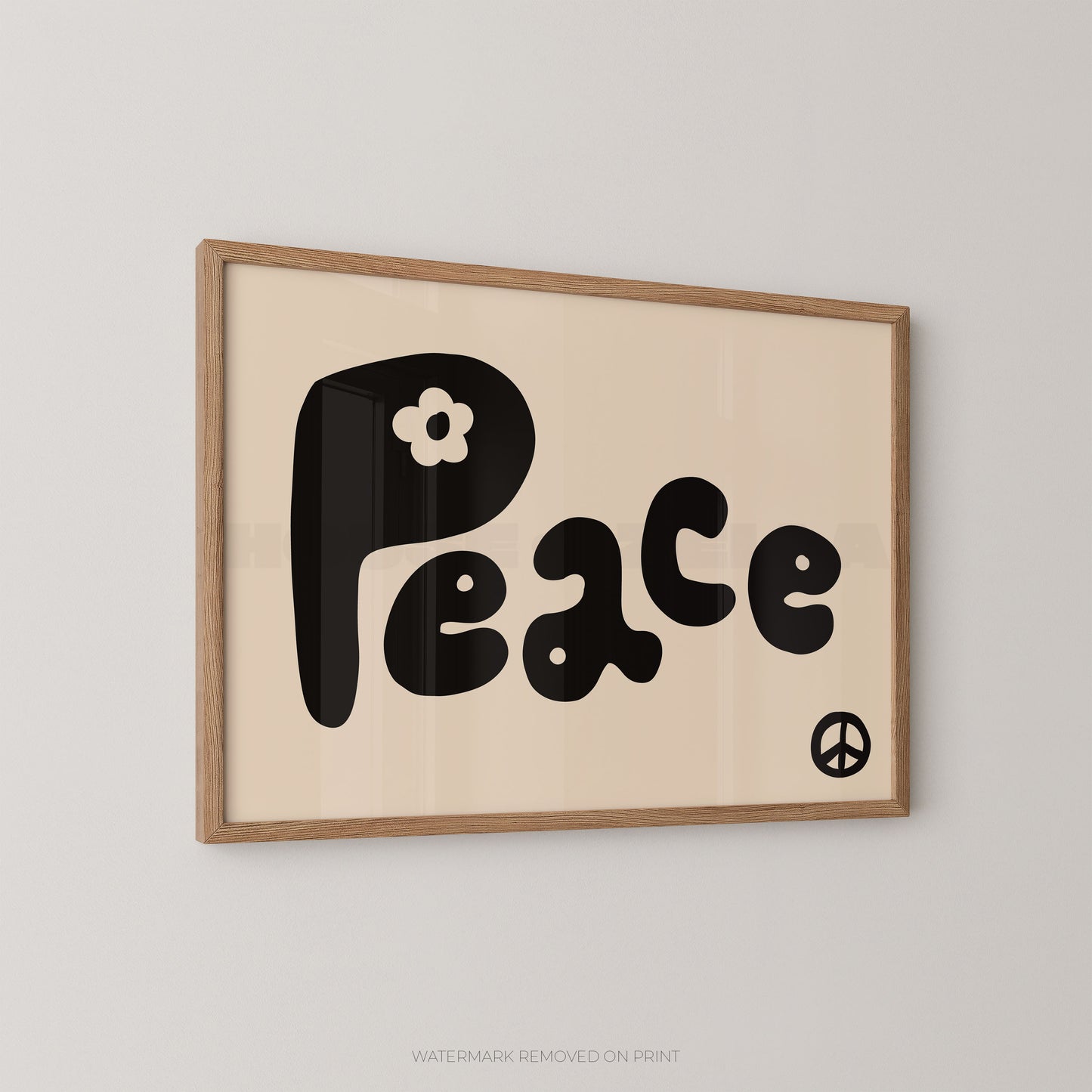 "Peace retro typography wall art print with bold bubbly black lettering and a white daisy flower on a cream background, with a small black peace symbol, displayed at an angle in an oak frame"

