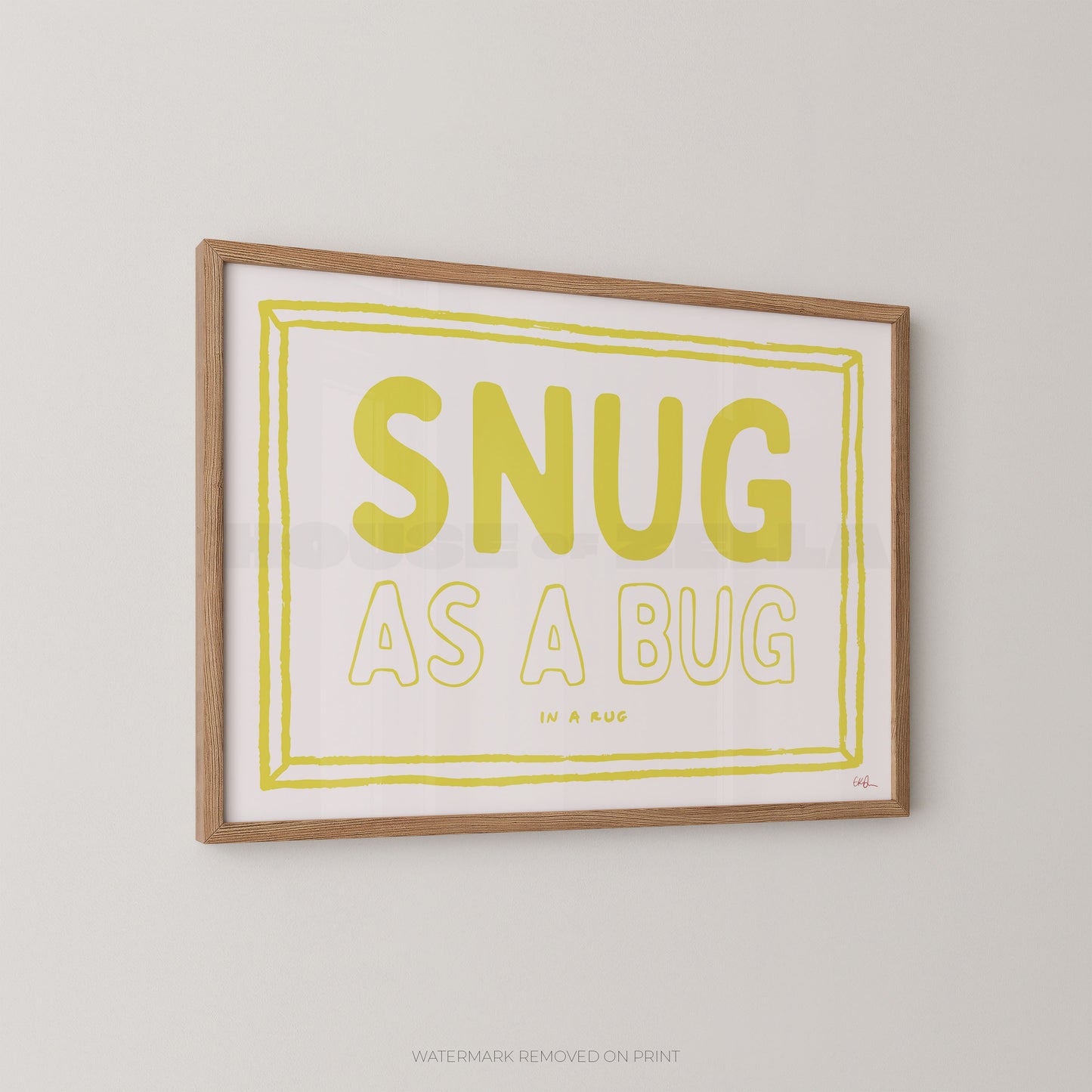 Framed print with 'SNUG AS A BUG' text on a plain wall