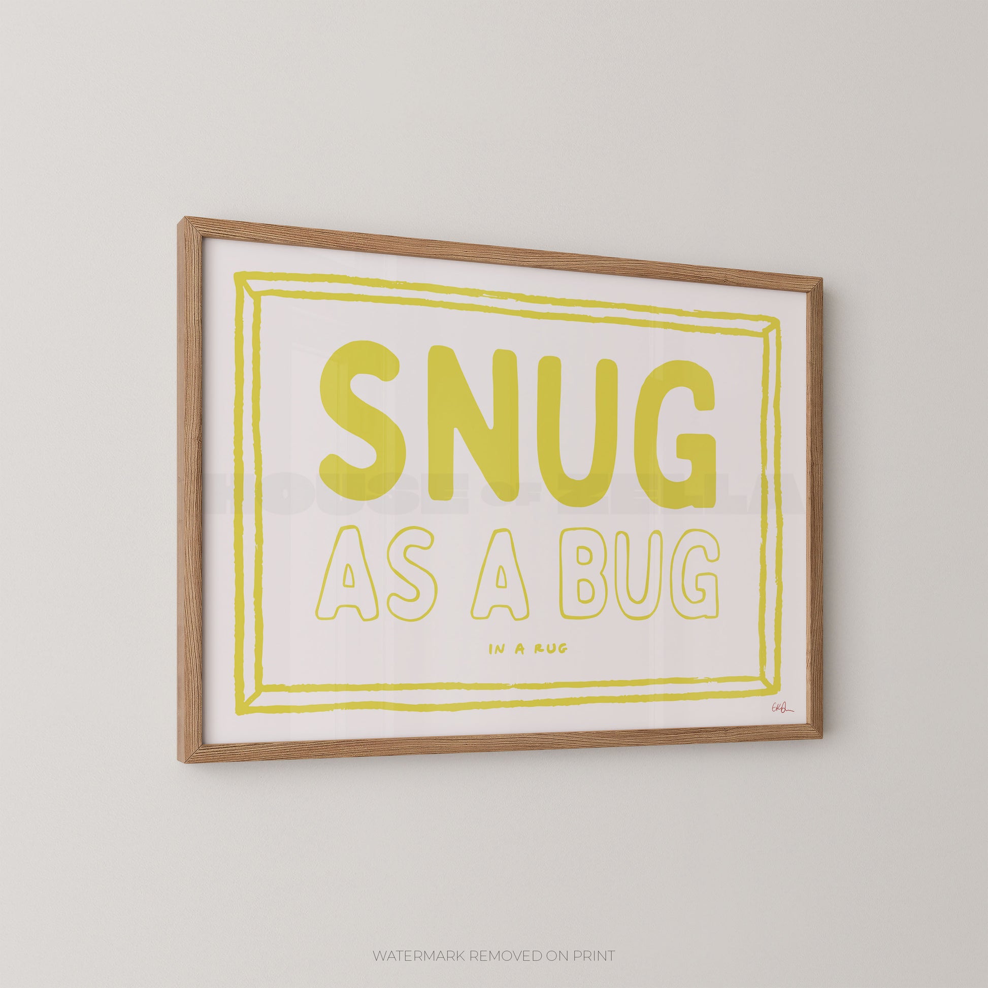 Framed print with 'SNUG AS A BUG' text on a plain wall