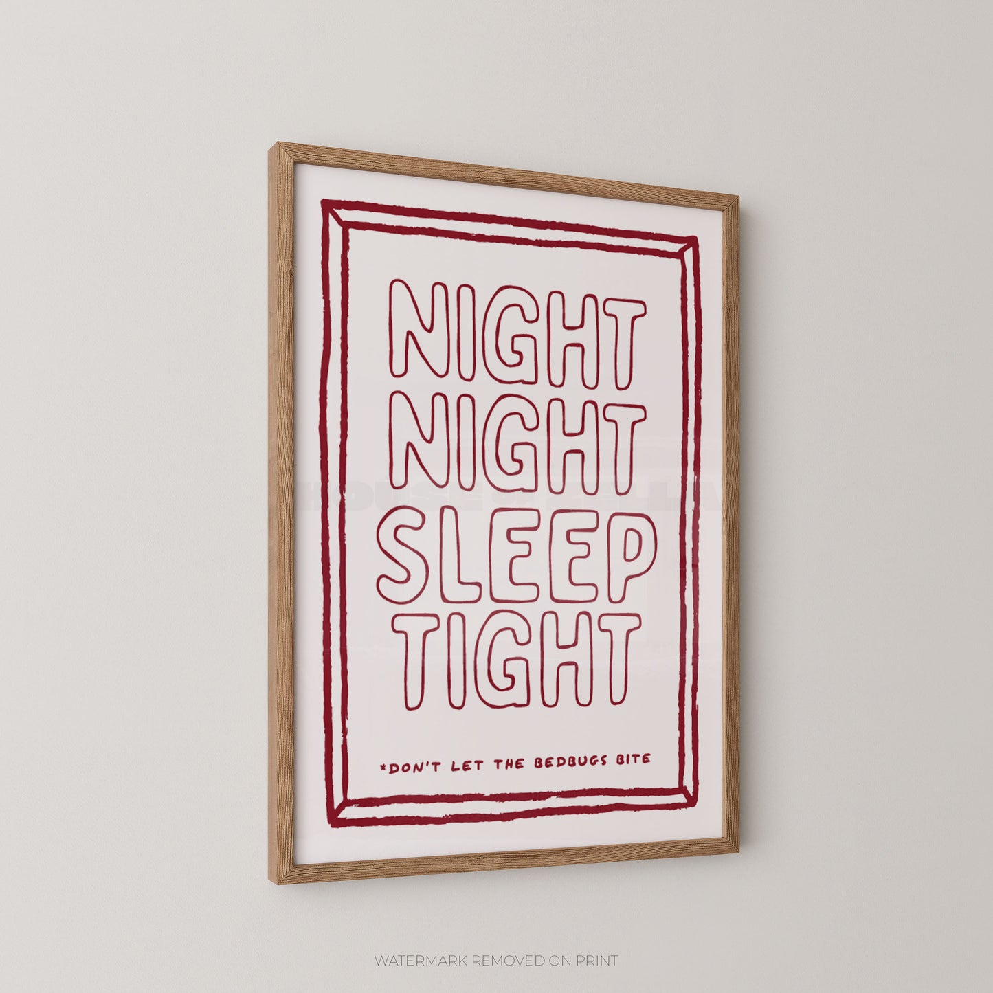 A framed typographic wall art print hanging on a light gray wall. The print has a white background with a red hand-drawn border and the words “NIGHT NIGHT SLEEP TIGHT” in large outlined red letters, plus smaller text reading “DON’T LET THE BEDBUG BITE.