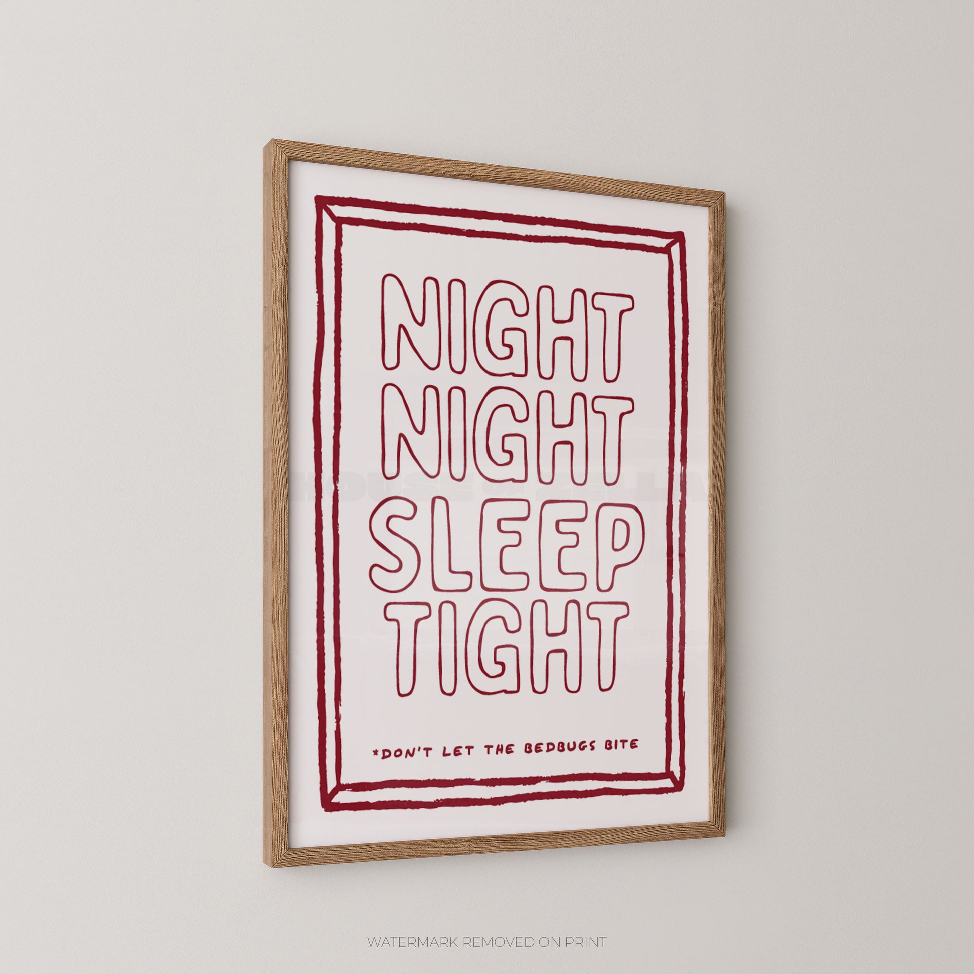 A framed typographic wall art print hanging on a light gray wall. The print has a white background with a red hand-drawn border and the words “NIGHT NIGHT SLEEP TIGHT” in large outlined red letters, plus smaller text reading “DON’T LET THE BEDBUG BITE.