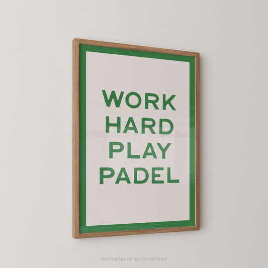 A framed typographic wall print with the words “WORK HARD PLAY PADEL” in green on a white background, bordered by a green inner frame and a natural wood outer frame, shown hanging on a light gray wall.