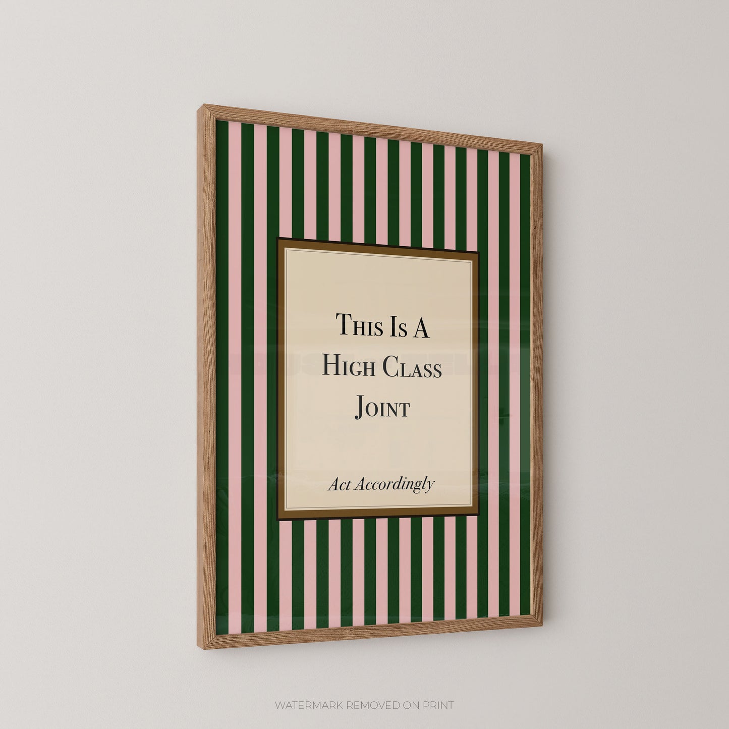 A framed wall art print with vertical green and cream stripes, featuring a central cream panel with the text 'This Is A High Class Joint' and smaller text 'Act Accordingly.' The frame is light wood.