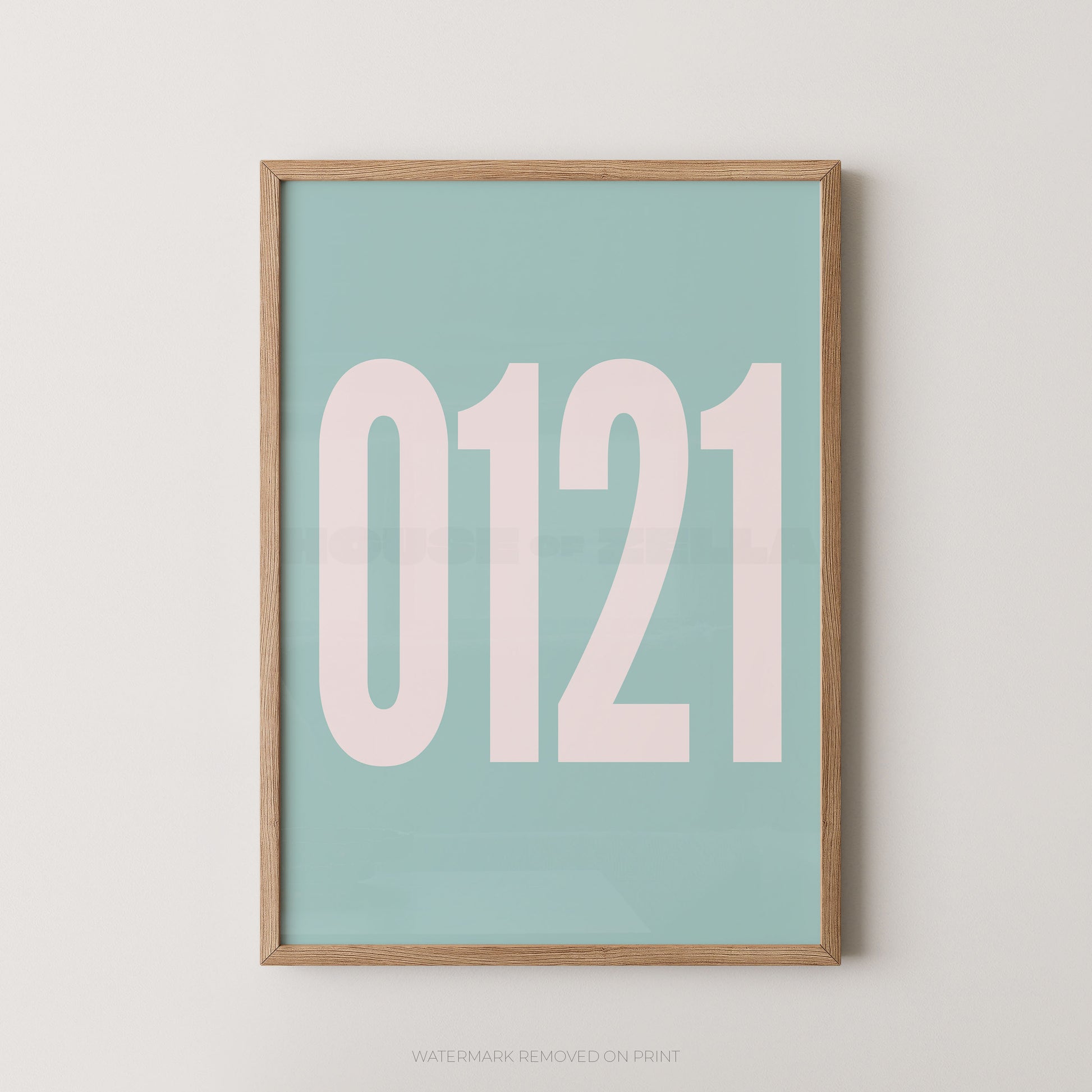 A framed minimalist art print featuring '0121' in white on a light blue background, enclosed in a natural wood frame.