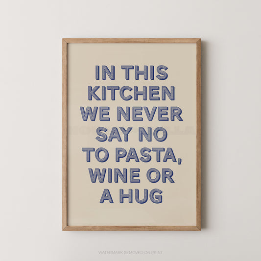 A framed typographic wall art print with the phrase “IN THIS KITCHEN WE NEVER SAY NO TO PASTA, WINE OR A HUG” in blue raised letters on a warm cream background, shown against a light neutral wall.