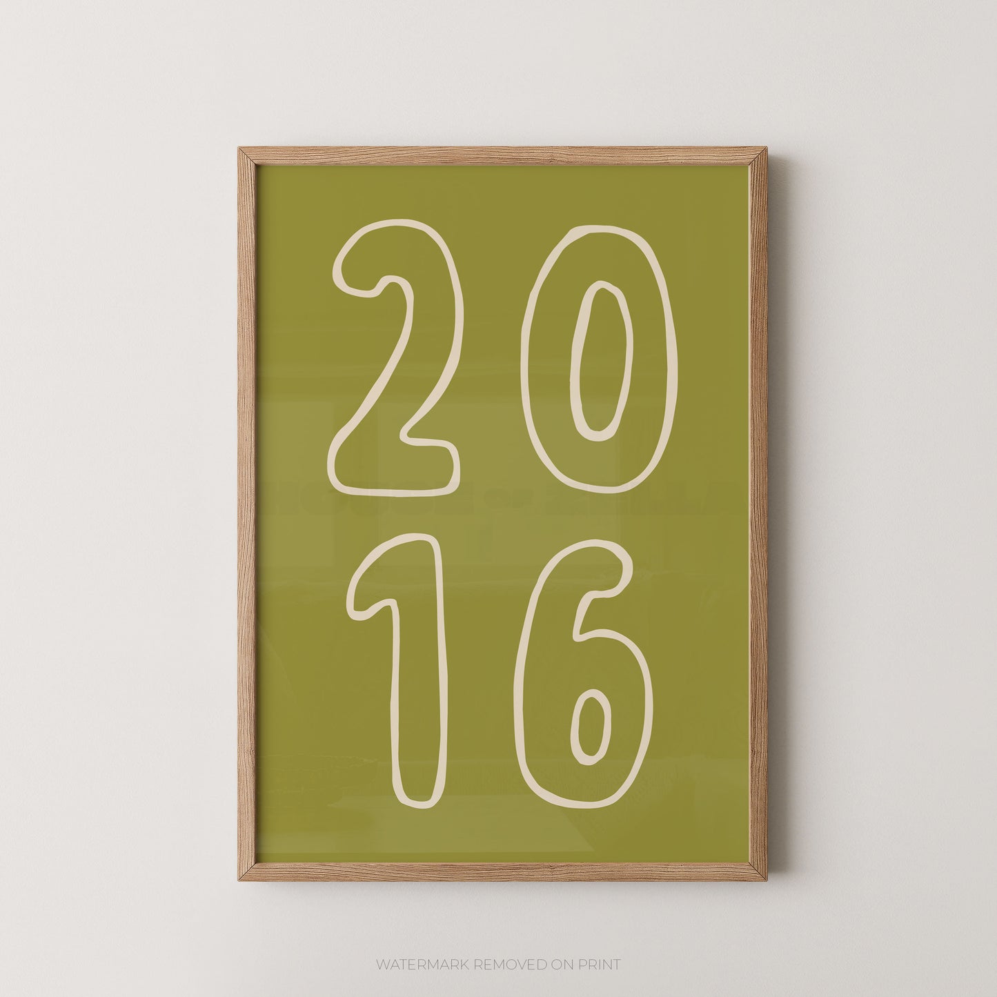 Framed wall art print with the numbers '2016' in white outline on an olive green background, shown in a light wood frame against a plain light gray wall.
