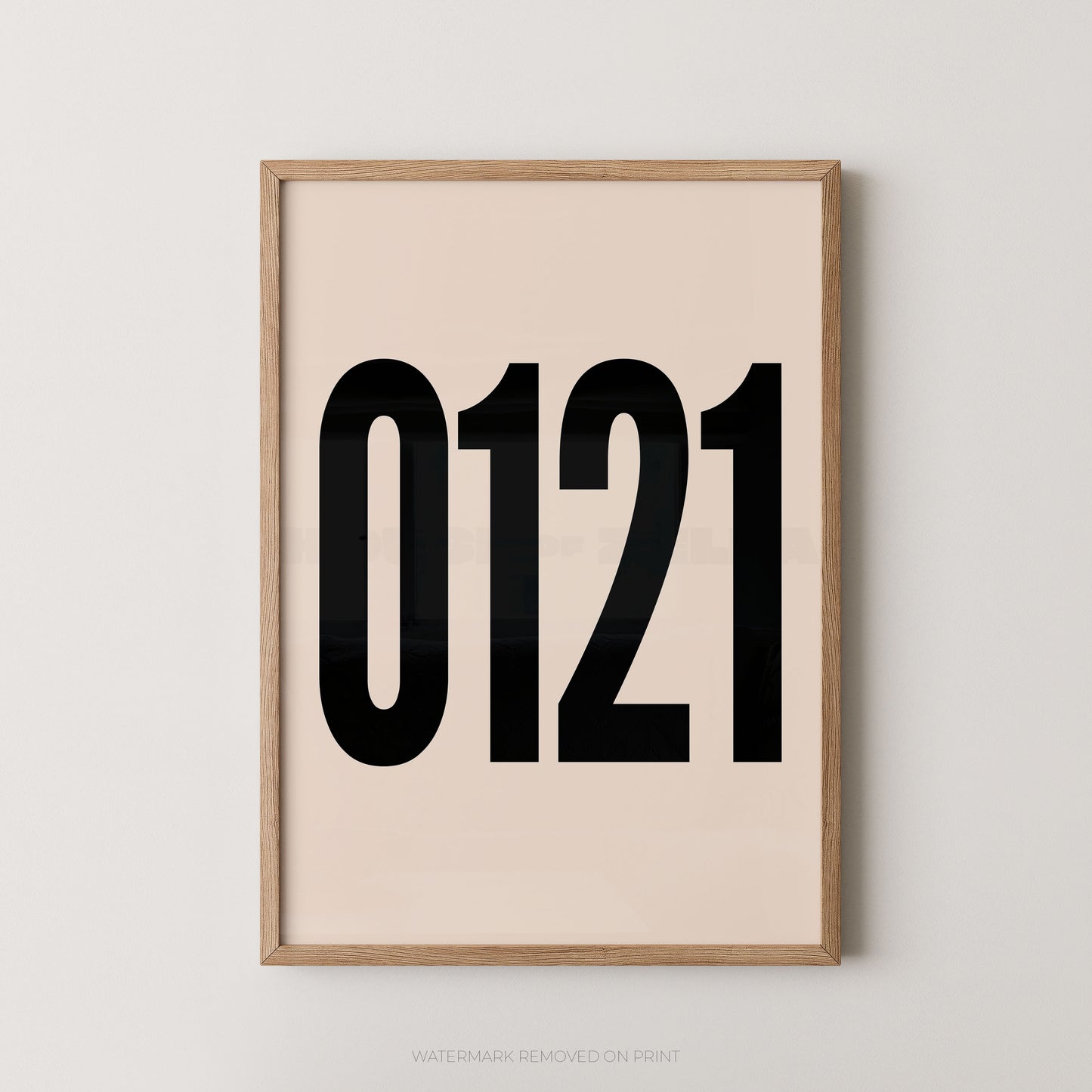 A framed minimalist art print featuring '0121' in black on a cream background, enclosed in a natural wood frame.